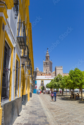 Yellow house and historic cathedral in Sevilla, Spain
