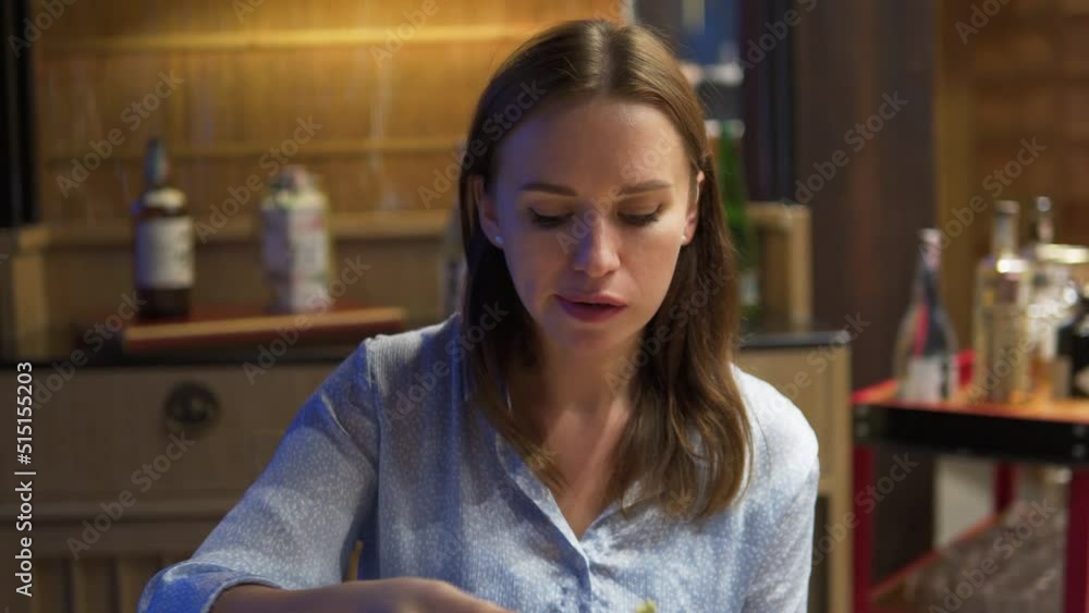 A static shot of a young beautiful brown girl eating food with the help of wooden chopstick in her house. Japanese style restaurant A static shot of a young beautiful brown girl eating food with the help of wooden chopstick in her house. Japanese style restaurant
