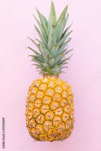 Ripe pineapple on a pink background