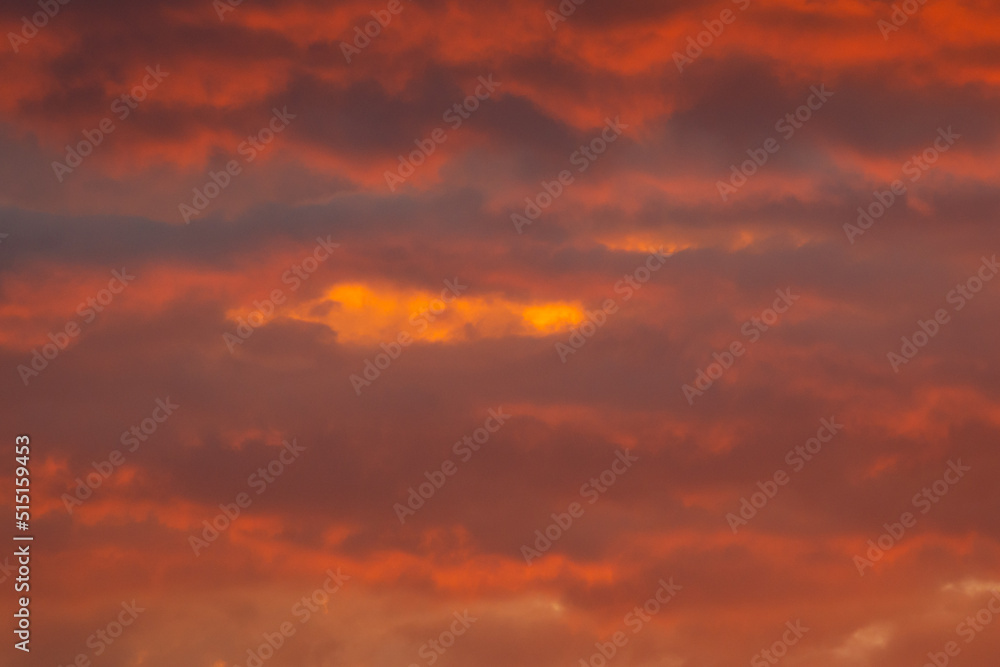 Colorful clouds of various shades on sunrise sky. Abstract and dramatic clouds background.