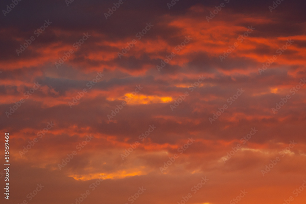 Colorful clouds of various shades on sunrise sky. Abstract and dramatic clouds background. Colorful clouds of various shades on sunrise sky. Abstract and dramatic clouds background.