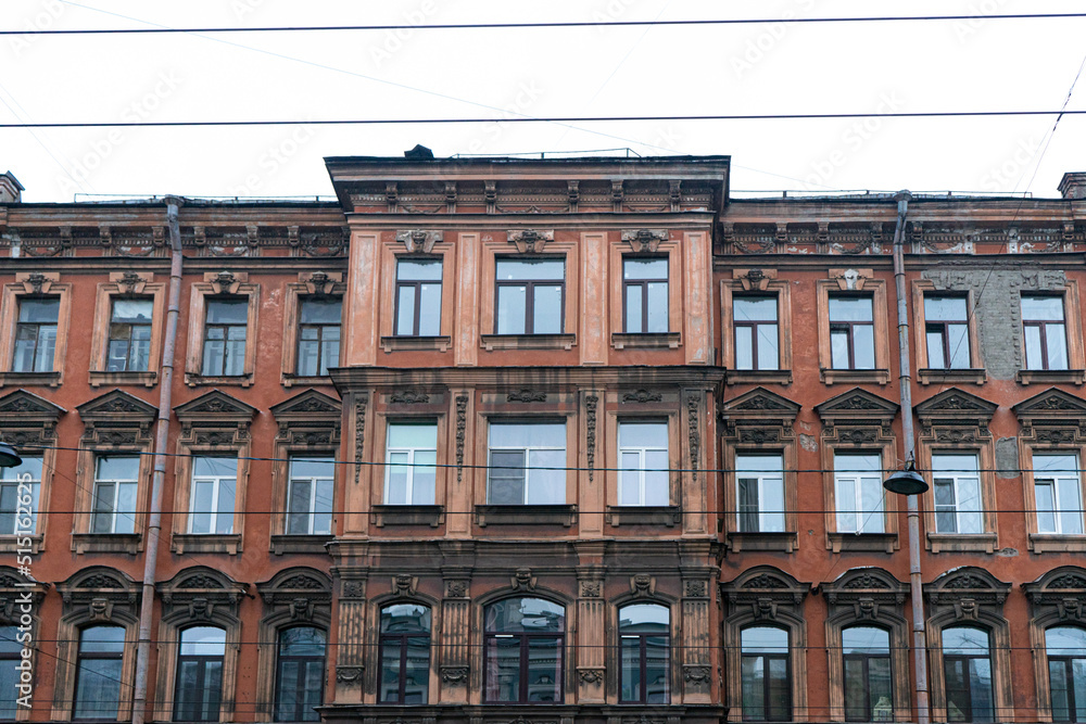 Minimalist architecture building facade of old historic house exterior. Decorative ornamental design elements of classic European style apartment building front view in Saint Petersburg, Russia