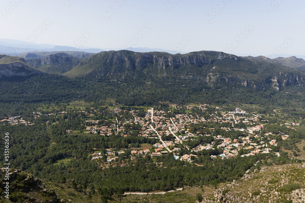 Suburb in a valley surrounded by mountains in Mediterranean landscape