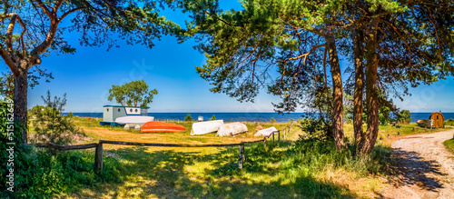 Fototapeta Naklejka Na Ścianę i Meble -  Panorama. Countryside landscape with old anchored fishing boats, village of fishermen on a beach of the Baltic Sea
