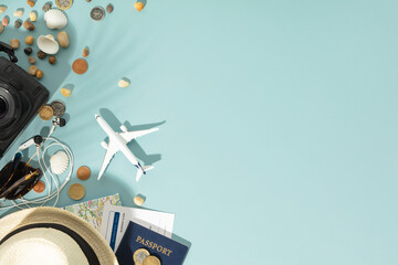 Miniature toy airplane, travel accessories and paper clouds on blue background. Flat lay design of travel concept