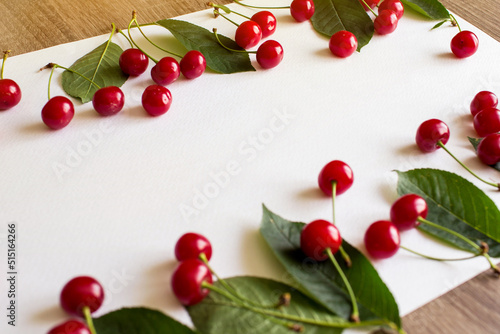 
Berry cherry background, banner, cover. Juicy cherries with leaves on a white background. There is space for text.