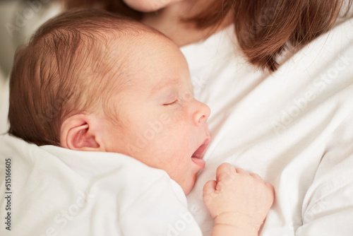 Newborn baby sleeping on the mother's chest