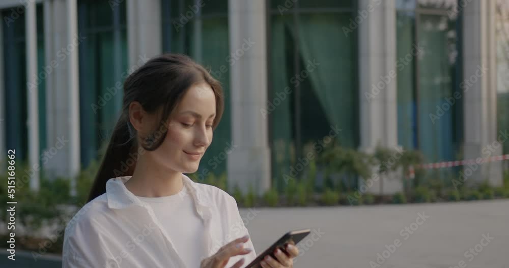 Portrait of happy hipster woman typing by mobile phone outdoors Portrait of happy hipster woman typing by mobile phone outdoors