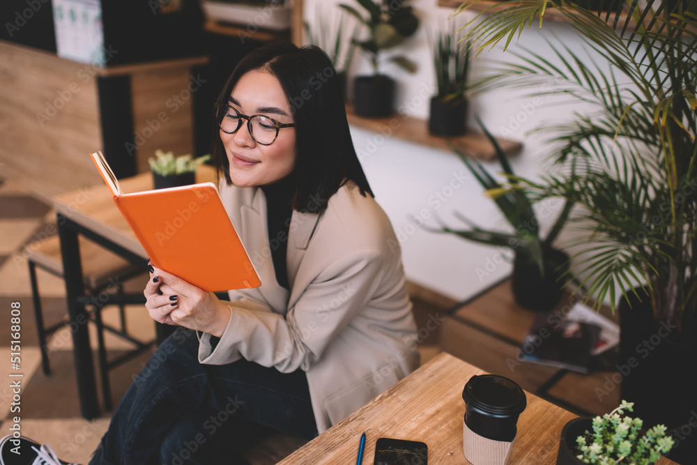 Obraz premium Young millennial asian girl resting in cafe