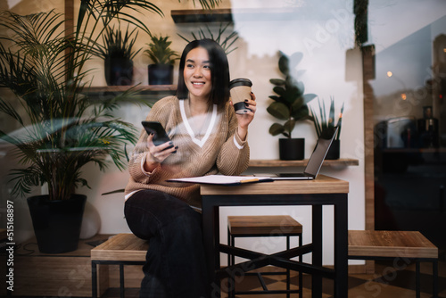 Young millennial asian businesswoman work in cafe
