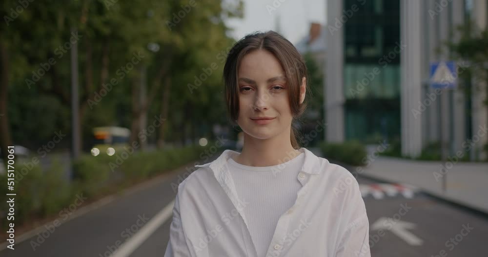 Trendy caucasian woman smiling at camera and looking confident while enjoying Trendy caucasian woman smiling at camera and looking confident while enjoying