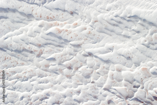 Background white and grey texture of Pamukkale calcium travertine in Turkey, abstract pattern, top view.