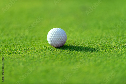 Golf ball on green grass of golf course. Horizontal sport theme poster, greeting cards, headers, website and app