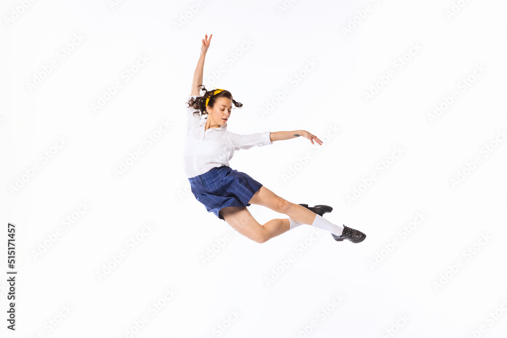 Portrait of beautiful young woman in retro outfit dancing, posing isolated over white studio background Portrait of beautiful young woman in retro outfit dancing, posing isolated over white studio background