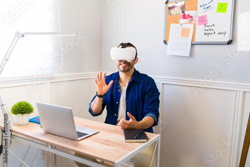 Young man wearing VR glasses and having a work video call