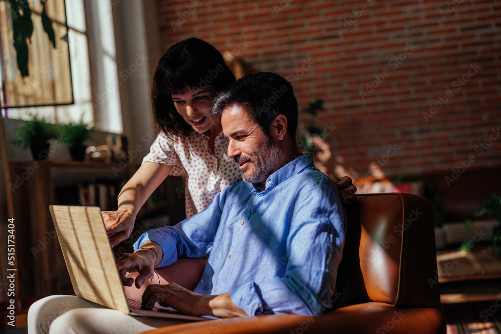 Mature couple looking travel destination on laptop Mature couple looking travel destination on laptop