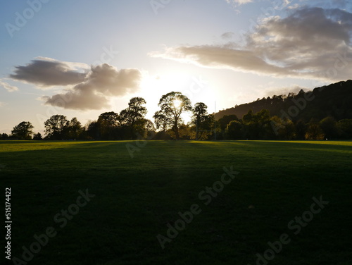 Dawn with sunbeams through a treeline in Stirling Scotland