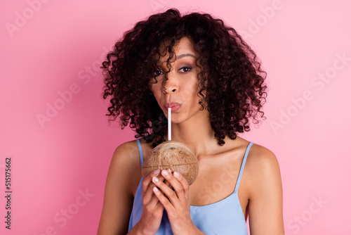 Portrait of adorable positive person hold coconut enjoy drink cocktail isolated on pink color background