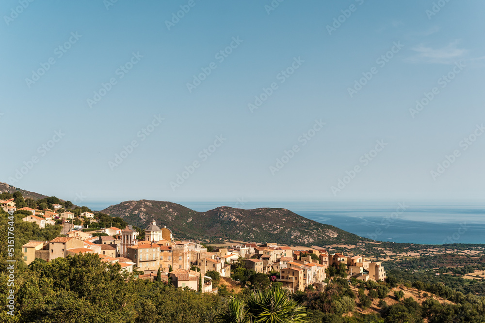 The village of Cateri in the Balagne region of Corsica with Mediterranean sea in the distance