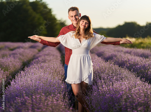 Fototapeta Naklejka Na Ścianę i Meble -  Young couple in a lavender field at sunset