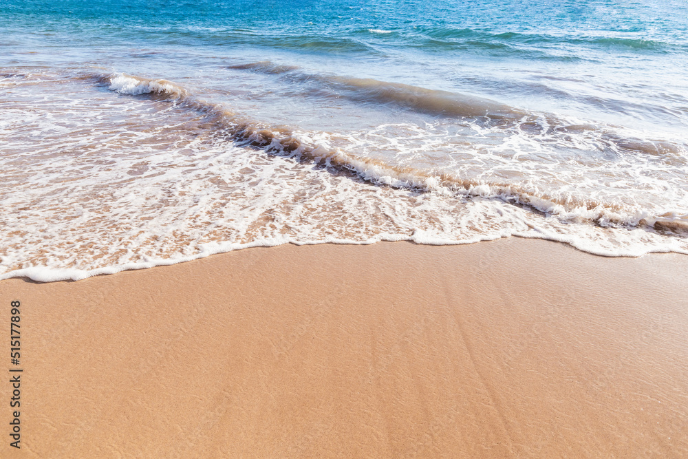 Maui Hawaii beach coastline of sand, sun, and blue water with crashing Maui Hawaii beach coastline of sand, sun, and blue water with crashing