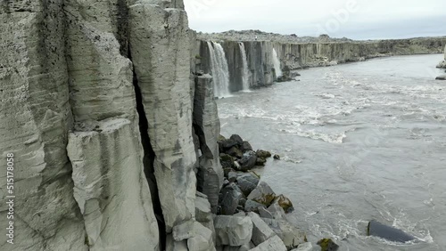 Revealing Droneshot of Waterfalls flowing into a River photo