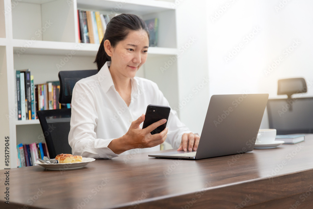 woman work using texting cell phone typing computer.student study education online learning.adult professional chatting on laptop,mobile contact us at Thinking business plan.connecting people concept woman work using texting cell phone typing computer.student study education online learning.adult professional chatting on laptop,mobile contact us at Thinking business plan.connecting people concept