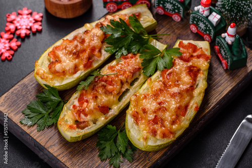 Baked stuffed zucchini boats with minced chicken mushrooms and vegetables with cheese. Christmas table