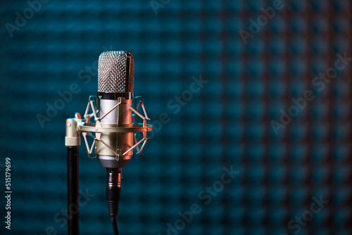 Studio condenser microphone on acoustic foam panel background