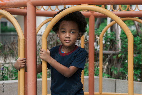 African kid smiling while playing at playground