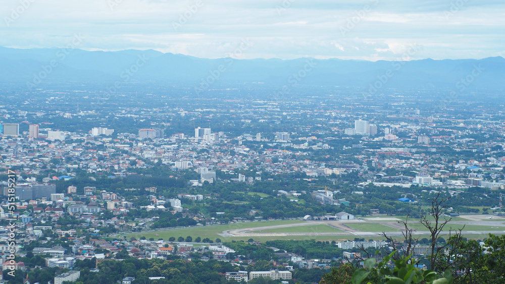 Obraz premium Chiang Mai City, bird's eye view from Doi Suthep, a city surrounded by trees, July 4, 2022 in Chiang Mai, Thailand (Industrial Concept) City