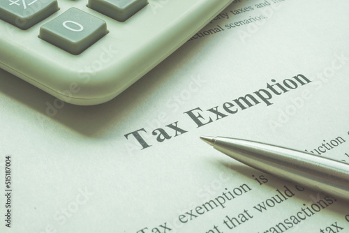 Info about tax exemption with calculator and pen.