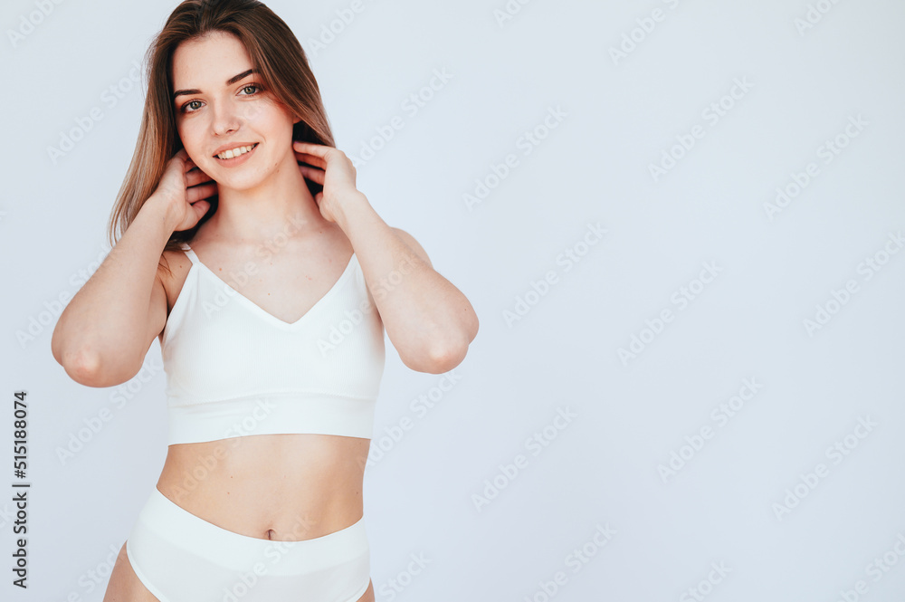 Woman With Perfect Figure stands on White Isolated Background. Girl in white sports underwear Woman With Perfect Figure stands on White Isolated Background. Girl in white sports underwear