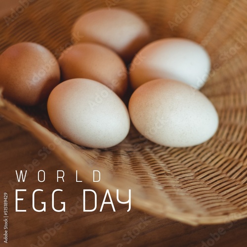 Digital composite image of white raw eggs in wicker basket and world egg day text