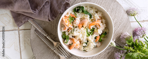 bowl of risotto with spinach and shrimp on the table