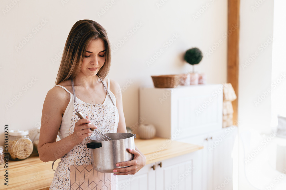 Culinary Blog of a Young Woman. Saucepan and Whisk in the Hands of a Cute Girl. Culinary Blog of a Young Woman. Saucepan and Whisk in the Hands of a Cute Girl.
