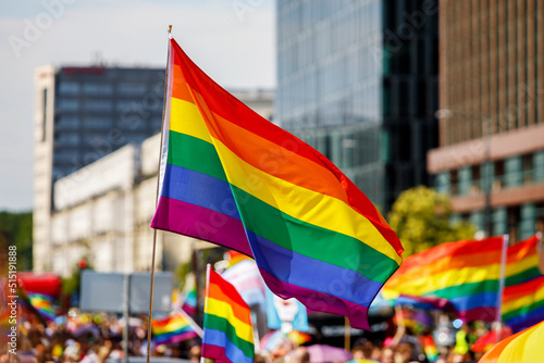 Fototapeta Lgbt pride rainbow flag during parade in the city .