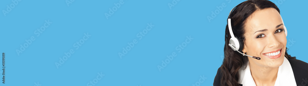 Call center service. Portrait image of female customer support phone sales operator in headset showing something or copy space area for text or slogan, isolated on blue background. Call center service. Portrait image of female customer support phone sales operator in headset showing something or copy space area for text or slogan, isolated on blue background.