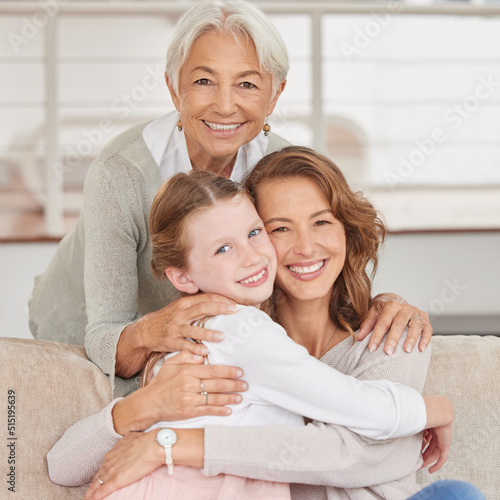 Portrait of a grandmother relaxing with her daughter and mother. Little girl bonding with her parent and grandparent in the living room at home. Three generations spending time together