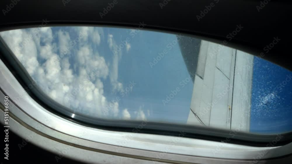 Shot from the window of an airplane while flying with white clouds Shot from the window of an airplane while flying with white clouds