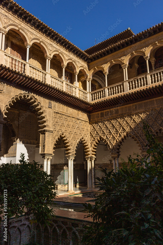 Fototapeta premium Seville, Spain, September 12, 2021: The Royal Palace of Seville (Real Alcazar). The Maidens Courtyard. The Mudejar of Pedro I on the ground floor and the Renaissance of the first monarchs.