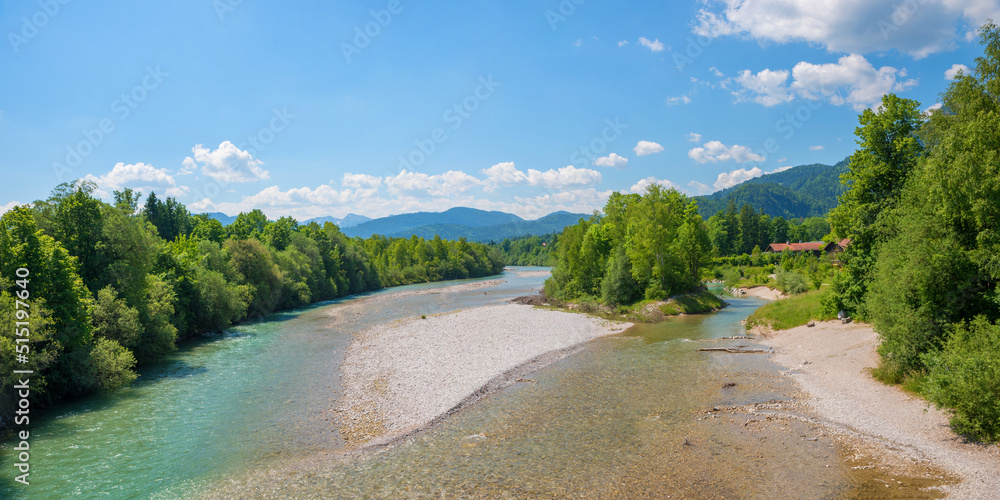 isar river with gravel banks, green riverside and alps view
