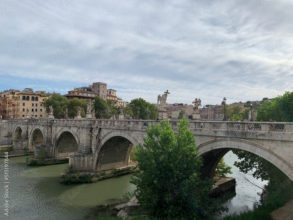 Ancient marble, stone St. Angelo Bridge (Ponte Sant'Angelo) over Tiber river at Roma city centre. Bridge has angels statues on it. It is popular sightseeing and tourists attraction place. Rome, Italy