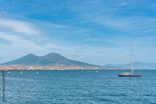 Boat navigating on Napoli bay in front of Vesuvio