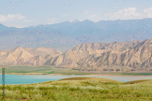 Beautiful landscape with Toktogul lake under colourful barren mountain range, Tien Shan range, Kyrgyzstan, Central Asia photo