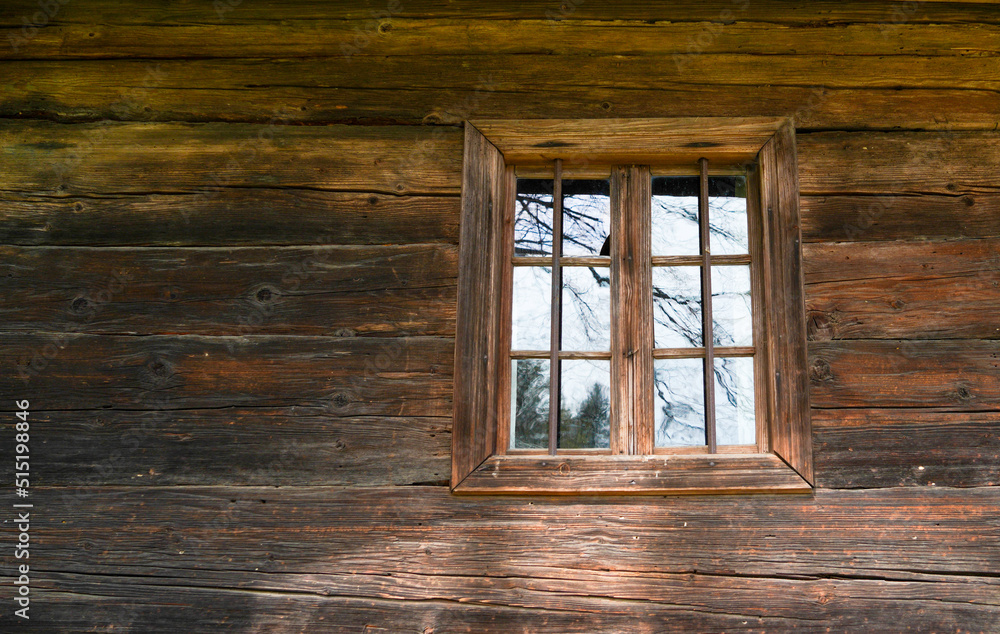 Aged wooden window with glazing and partially weathered in rustic homes Aged wooden window with glazing and partially weathered in rustic homes