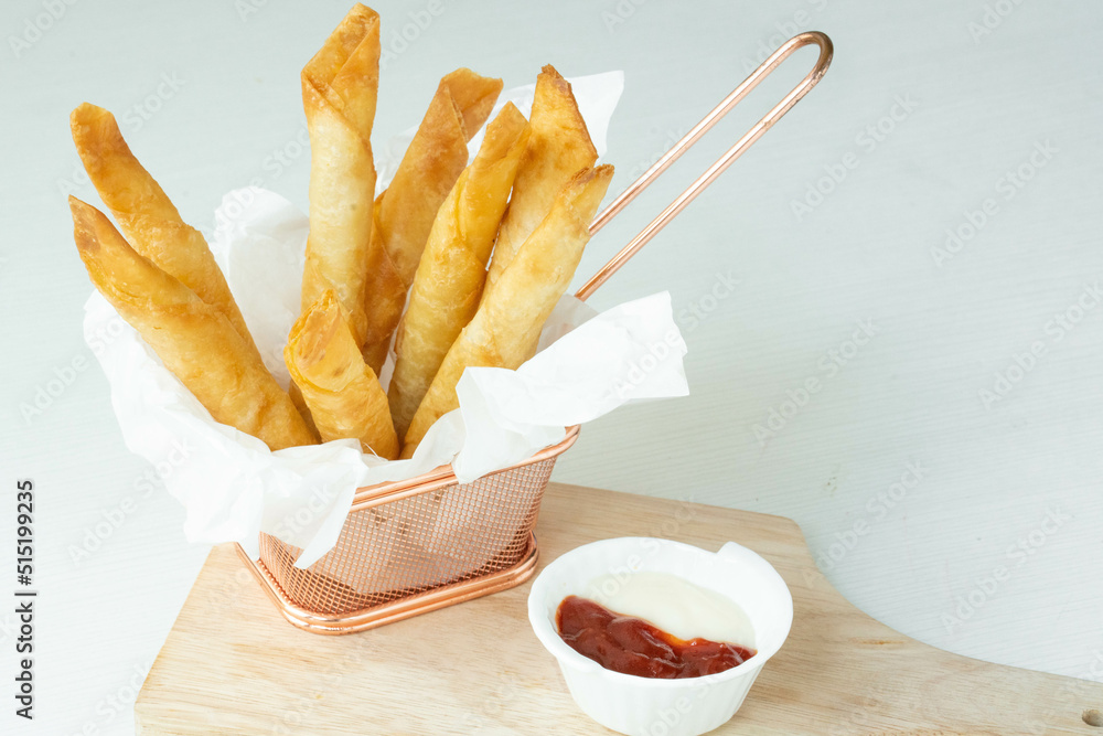 Homemade Fried Breaded mozzarella cheese sticks served with tomato sauce and mayonnaise on white background