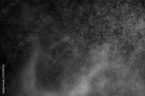 Sprayed water. Small droplets of water in the air. Lots of water drops, isolated on black background.