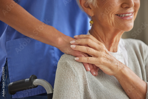 Closeup of a doctor comforting and supporting a patient by holding hands. Healthcare professional showing kindness to an elderly patient. Loving helper consoling a trusting patient through recovery photo