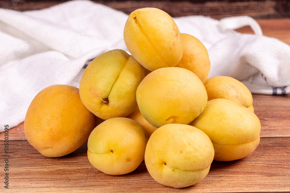 Apricots on wood background. Pile of fresh apricots. close up